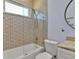 Contemporary bathroom with tub, shower, glass screen, patterned tiles, and round mirror at 4419 Swift Cir, Valrico, FL 33596