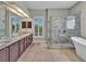Bathroom with a freestanding tub, marble-tiled shower, dual vanity, and ample counter space at 4419 Swift Cir, Valrico, FL 33596
