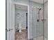 Modern bathroom featuring a glass shower, toilet, vanity, and stylish geometric-patterned tile floors at 4419 Swift Cir, Valrico, FL 33596
