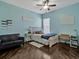 Cozy bedroom featuring a ceiling fan, a window and a white-painted wood frame bed at 4419 Swift Cir, Valrico, FL 33596