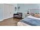 Cozy bedroom with full sized bed, closet, dark grey love seat and light blue color scheme at 4419 Swift Cir, Valrico, FL 33596