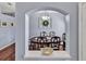 Dining room with wood table, chairs, chandelier, and view from a decorative archway at 4419 Swift Cir, Valrico, FL 33596