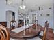 Open-concept dining area boasts a large wood table, chandelier, and views to other rooms at 4419 Swift Cir, Valrico, FL 33596