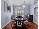 Elegant dining room features a wood table, six chairs, chandelier, and large window at 4419 Swift Cir, Valrico, FL 33596