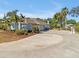 Spacious concrete driveway leading to a charming home with a side-entry garage, lush landscaping, and a basketball hoop at 4419 Swift Cir, Valrico, FL 33596