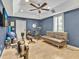 Home exercise room featuring exercise equipment, a comfortable sofa, and bright, neutral walls at 4419 Swift Cir, Valrico, FL 33596