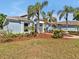 Charming home with mature trees, landscaped yard, and a brick pathway leading to the front entrance at 4419 Swift Cir, Valrico, FL 33596