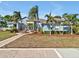 Charming home featuring lush landscaping, mature palm trees, and a welcoming brick pathway to the entrance at 4419 Swift Cir, Valrico, FL 33596