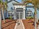 Inviting front entrance with decorative double doors and sidelight windows surrounded by beautiful foliage at 4419 Swift Cir, Valrico, FL 33596