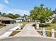 Charming single-story home showcasing a lengthy driveway and lush green landscaping, providing serene curb appeal at 4419 Swift Cir, Valrico, FL 33596