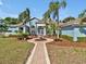 Beautifully landscaped front yard featuring a decorative fountain and a brick pathway leading to the house at 4419 Swift Cir, Valrico, FL 33596