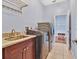 Functional laundry room with sink, modern washer and dryer, and a door to another room at 4419 Swift Cir, Valrico, FL 33596