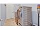 A laundry room showcases a modern washer and dryer, with a door leading outside at 4419 Swift Cir, Valrico, FL 33596