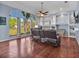 Spacious living room featuring hardwood floors, comfortable seating, and a large window offering scenic views at 4419 Swift Cir, Valrico, FL 33596