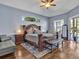 Elegant main bedroom featuring a luxurious wooden bed frame, wood floors, and serene blue walls at 4419 Swift Cir, Valrico, FL 33596