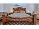 Spacious main bedroom featuring a decorative wooden bed frame, plush bedding, and stylish decor at 4419 Swift Cir, Valrico, FL 33596