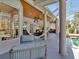 Relaxing screened-in patio with comfortable seating, hammock, TV, and views of the sparkling pool at 4419 Swift Cir, Valrico, FL 33596