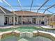 Private screened pool and spa area with an expansive covered patio, ideal for entertaining and relaxation at 4419 Swift Cir, Valrico, FL 33596