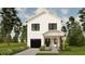 Charming two-story home features a black garage door, green front door, and lush landscaping, creating great curb appeal at 4995 16Th N Ave, St Petersburg, FL 33710