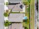 An aerial view showcases a home with solar panels, a fire pit, and a backyard pool at 5946 81St N Ave, Pinellas Park, FL 33781