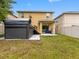Backyard featuring a swim spa, covered patio, and well-maintained lawn at 5946 81St N Ave, Pinellas Park, FL 33781