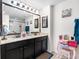 Bright bathroom with a double sink vanity, a large mirror, and vanity lights offering great illumination at 5946 81St N Ave, Pinellas Park, FL 33781