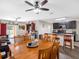 Spacious dining area open to the kitchen features a wood table, chairs, and ceiling fan at 5946 81St N Ave, Pinellas Park, FL 33781