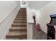 Staircase leading to the upper level with a view of the hallway, and fun game machines at 5946 81St N Ave, Pinellas Park, FL 33781