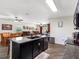 Kitchen island with granite countertop and open floor plan view into dining and living areas at 5946 81St N Ave, Pinellas Park, FL 33781