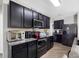 Well-equipped kitchen featuring stainless steel appliances, granite countertops, and sleek black cabinetry at 5946 81St N Ave, Pinellas Park, FL 33781
