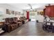 Relaxing living room with multiple brown leather sofas, fan, paintings, and backyard access at 5946 81St N Ave, Pinellas Park, FL 33781