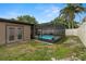 Lush backyard highlighting an enclosed pool and well-manicured lawn for serene outdoor living at 611 Limetree Dr, Oldsmar, FL 34677