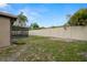 Large, grassy backyard featuring a fence and screened-in pool, ideal for relaxation at 611 Limetree Dr, Oldsmar, FL 34677