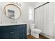 Clean bathroom showcasing modern vanity, round mirror, and bright natural lighting at 611 Limetree Dr, Oldsmar, FL 34677