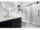 Stylishly remodeled bathroom features modern fixtures, a vanity, and a tiled shower with a glass door at 611 Limetree Dr, Oldsmar, FL 34677