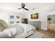 A primary bedroom includes a ceiling fan, two dressers, access to the pool, and a door to the hallway at 611 Limetree Dr, Oldsmar, FL 34677