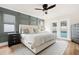 Beautiful bedroom with a king bed, panel accent wall, ceiling fan, and access to the pool area at 611 Limetree Dr, Oldsmar, FL 34677