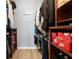 Spacious walk-in closet with wood shelving and plenty of room for storage, clothing and shoes at 611 Limetree Dr, Oldsmar, FL 34677