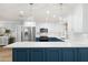 Bright modern kitchen with stainless appliances, white cabinets and a large center island at 611 Limetree Dr, Oldsmar, FL 34677