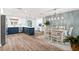 Open concept kitchen with stainless appliances, white countertops, and island seating at 611 Limetree Dr, Oldsmar, FL 34677