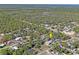 Further out aerial view of neighborhood highlighting proximity to wooded area at 7169 Spruce Dr, Weeki Wachee, FL 34607
