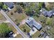 Wide aerial shot of the home showing the surrounding neighborhood, tree coverage, and street access at 7169 Spruce Dr, Weeki Wachee, FL 34607