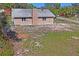 Back exterior view featuring the roof, chimney, and yard at 7169 Spruce Dr, Weeki Wachee, FL 34607