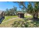 A backyard shed with lush green grass, and plenty of shade from the Florida sun at 7169 Spruce Dr, Weeki Wachee, FL 34607