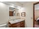 Bathroom featuring a vanity sink, wallpaper, and mirror at 7169 Spruce Dr, Weeki Wachee, FL 34607