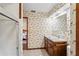 A full bathroom with a shower, toilet, sink with a dark wooden cabinet, and tiled flooring at 7169 Spruce Dr, Weeki Wachee, FL 34607