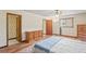 This bedroom has a light and bright airy feel with a ceiling fan, wood floors and a window at 7169 Spruce Dr, Weeki Wachee, FL 34607