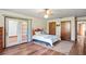 Bright bedroom featuring wood floors, ceiling fan and French doors to the outside at 7169 Spruce Dr, Weeki Wachee, FL 34607
