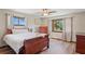 Comfortable bedroom with wood flooring, windows, and ceiling fan at 7169 Spruce Dr, Weeki Wachee, FL 34607