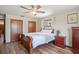 Cozy bedroom featuring wood flooring, ceiling fan, closet, and natural light at 7169 Spruce Dr, Weeki Wachee, FL 34607